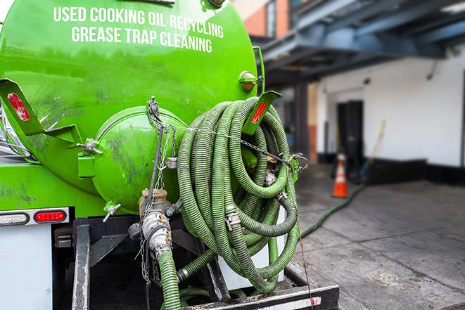 a large grease trap being pumped by a specialist in Brooklyn